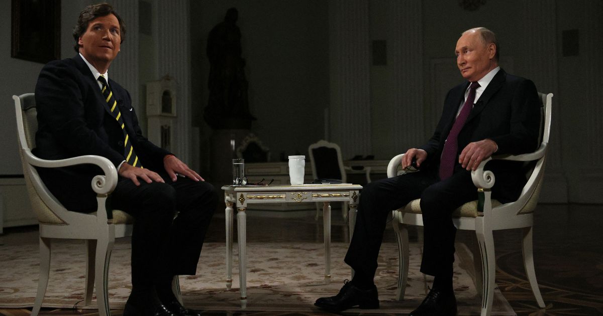 Tucker Carlson, left, interviews Russian President Vladimir Putin in Moscow, Russia, on Feb. 6.
