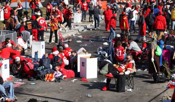 People take cover during a shooting at the Super Bowl LVIII parade for the Kansas City Chiefs in Kansas City, Missouri, on Wednesday.