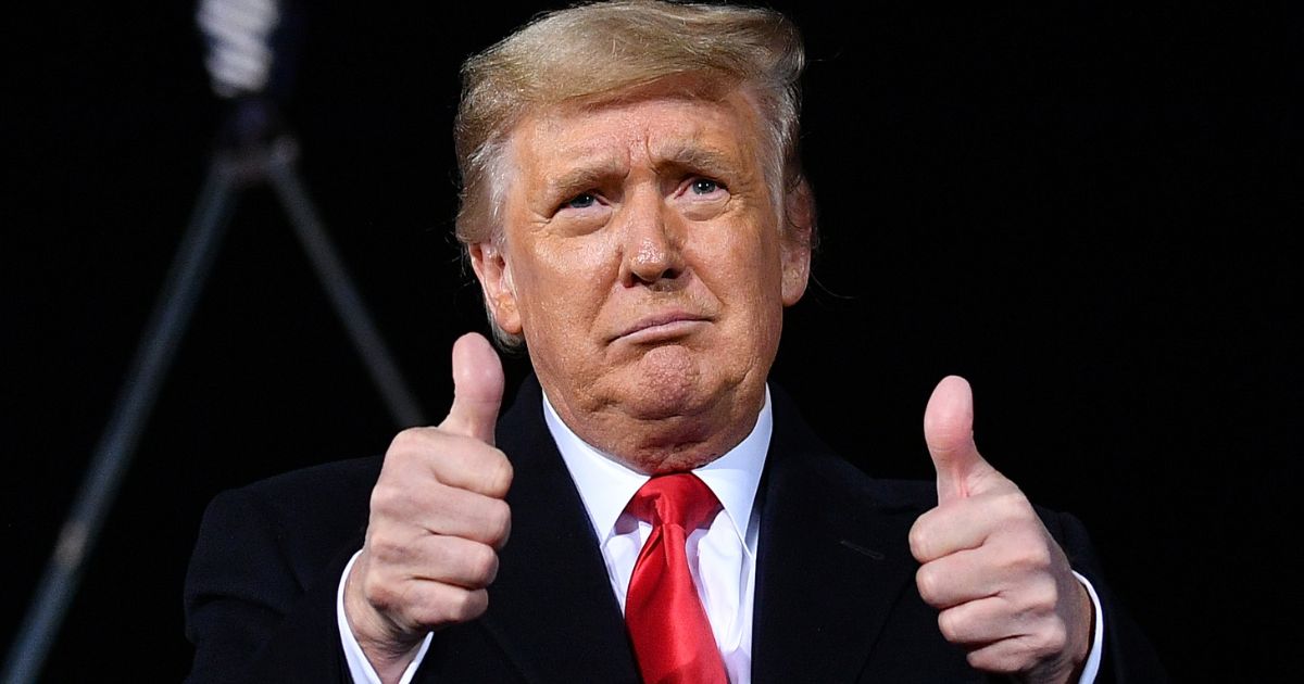Then-President Donald Trump holds two thumbs up at a campaign rally for incumbent Sens. Kelly Loeffler and David Perdue ahead of Senate runoff in Dalton, Georgia on Jan. 4, 2021.