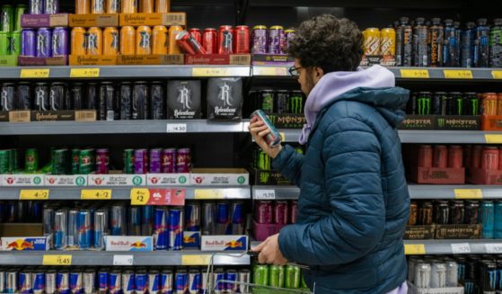 A man shops for energy drinks in a supermarket. New research suggests that energy drinks can be extremely harmful to children.