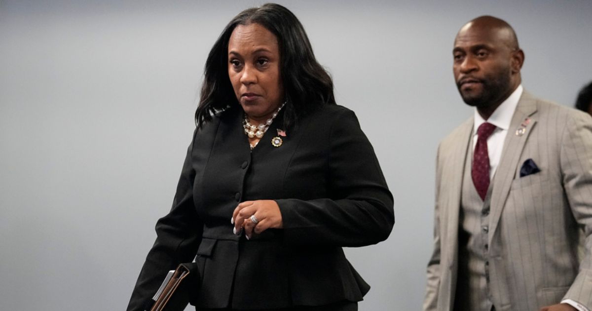 Fulton County District Attorney Fani Willis, followed by special prosecutor Nathan Wade, right, arrives for a news conference at the Fulton County Government Center, Aug. 14, in Atlanta. Willis acknowledged in a court filing on Friday having a “personal relationship” with Wade, a special prosecutor she hired for the Georgia election interference case against former President Donald Trump.