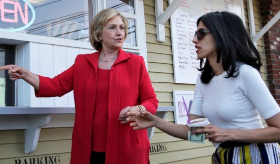 Hillary Clinton and her personal aide Huma Abedin approach a window to buy ice cream in New Hampshire during the 2016 primary