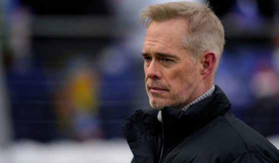 ESPN broadcaster Joe Buck walks the field before an NFL football AFC divisional playoff game between the Baltimore Ravens and the Houston Texans, Jan. 20, in Baltimore.