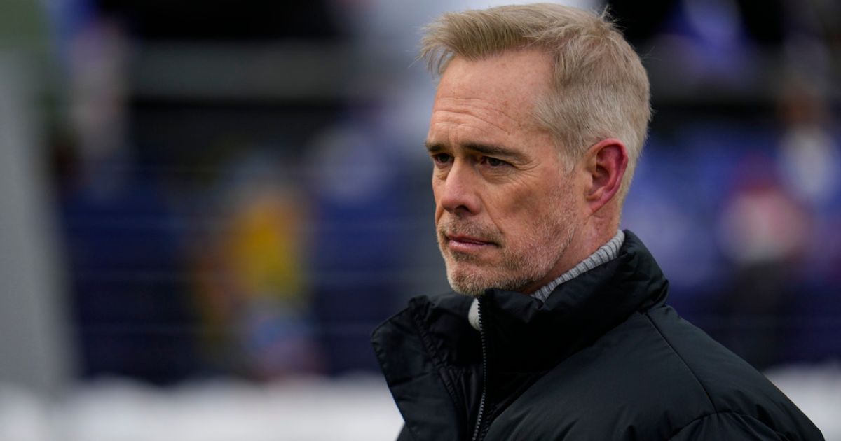 ESPN broadcaster Joe Buck walks the field before an NFL football AFC divisional playoff game between the Baltimore Ravens and the Houston Texans, Jan. 20, in Baltimore.