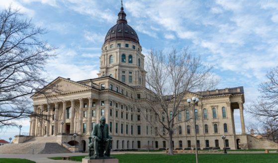 A stock photo shows the Kansas state Capitol, with a statue of Abraham Lincoln in the foreground, in Topeka on March 27, 2021.