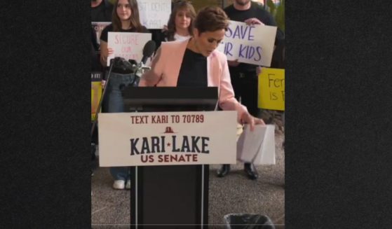 Senate candidate Kari Lake threw a copy of Congress' border bill in a wastebasket Wednesday, saying that's where the flawed plan belongs.