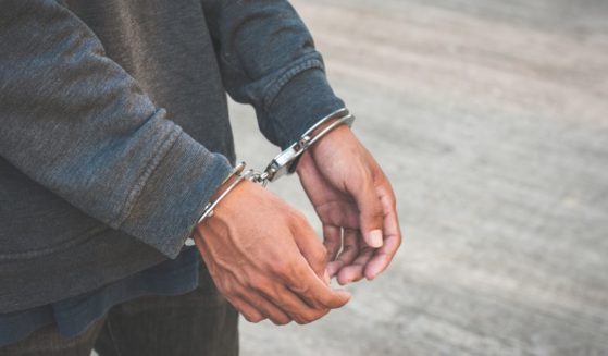 A close-up of a man wearing handcuffs.