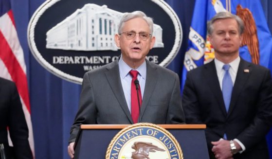 Merrick Garland speaking with reporters during a news conference in Washington