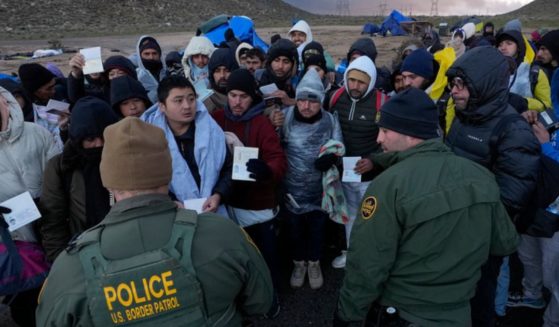 U.S. Border Patrol agents on Friday spoke with migrants seeking asylum, mainly from Colombia, China and Ecuador, after crossing the border between Mexico and the U.S. near Jacumba, California.