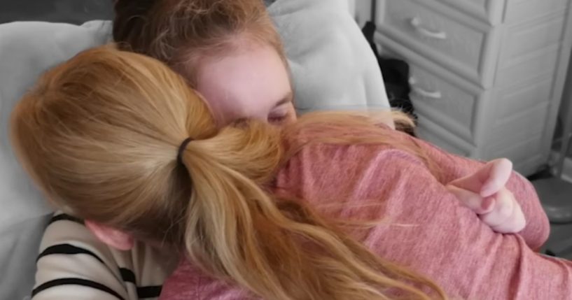 Peggy Means, top, hugs her daughter Jennifer Flewellen. Flewellen went into a coma for five years following a car accident in 2017, but despite doctors' advice to remove her from life support, Means continued to hope that God would heal her daughter, who eventually woke up from her coma in August 2022.