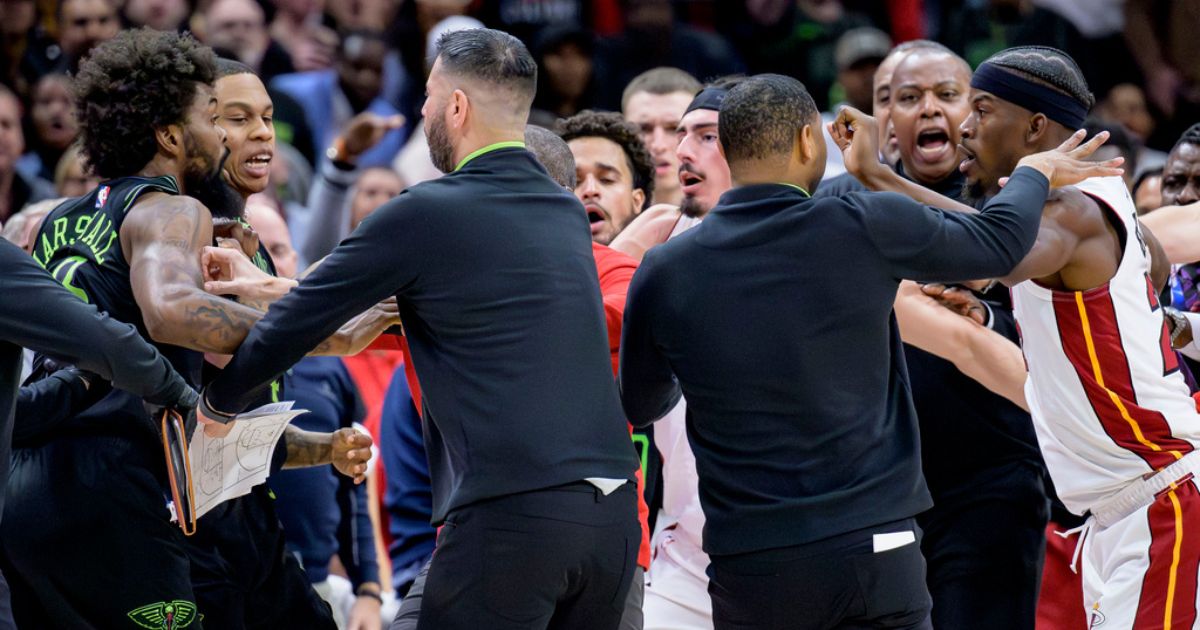New Orleans Pelicans forward Naji Marshall, left, and Miami Heat forward Jimmy Butler, right, are separated during a scuffle in the second half of an NBA basketball game in New Orleans on Friday.