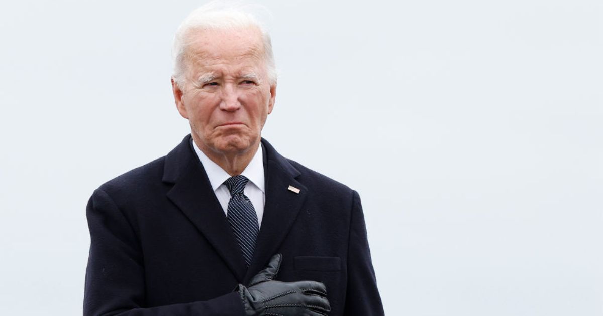 President Joe Biden places his hand over his heart Friday during the dignified transfer of fallen service members U.S. Army Sgt. William Rivers, Sgt. Breonna Moffett and Sgt. Kennedy Sanders, at Dover Air Force Base in Dover, Delaware.