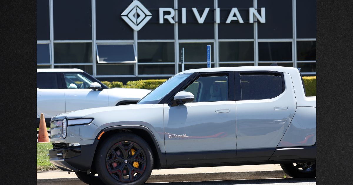 A Rivian electric truck sits parked in front of a Rivian service center on Aug. 8, 2023, in South San Francisco, California.