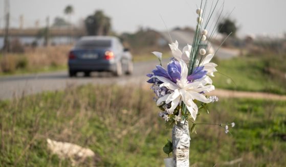 A stock photo shows a bouquet set up as a roadside memorial at the site of a fatal crash.