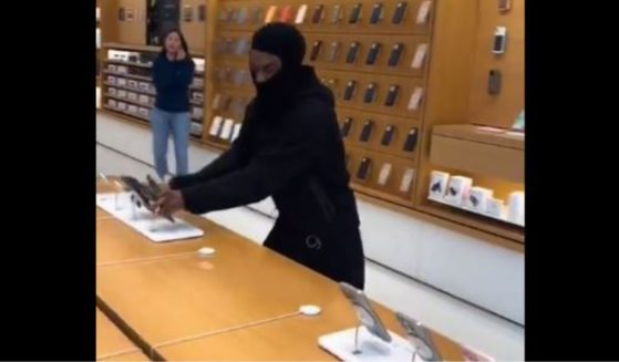 A video that went viral on social media shows a man ripping iPhones and other Apple merchandise from a store display Monday in Emeryville, California.