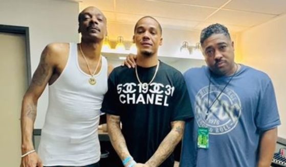 Hip-hop star Snoop Dogg (left) reported Friday on Instagram that his brother, Bing Worthington, (right) has died. The man in the middle is unidentified.