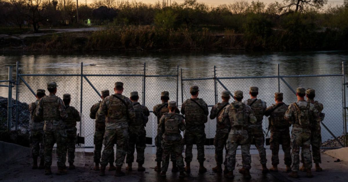 Texas National Guard soldiers stand guard on the banks of the Rio Grande river at Shelby Park in Eagle Pass, Texas, on Jan. 12.