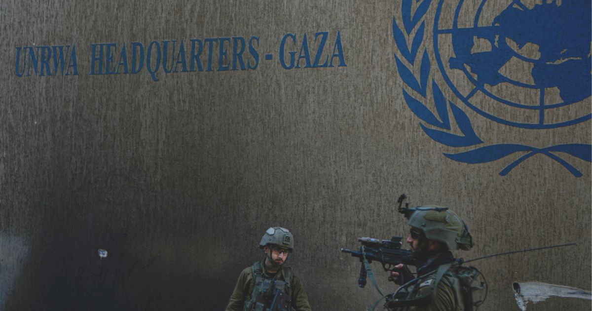 Israeli soldiers take up position as they enter the UNRWA headquarters Thursday, where the military discovered tunnels underneath the U.N. agency that the military says Hamas militants used to attack its forces during a ground operation in Gaza.