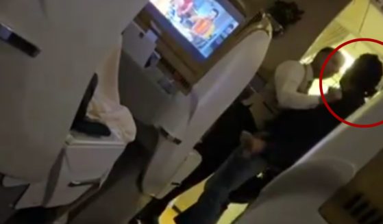While on a flight from Dubai to Islamabad on Sunday, a male passenger, right, assaulted a flight attendant and was promptly restrained by crew members.