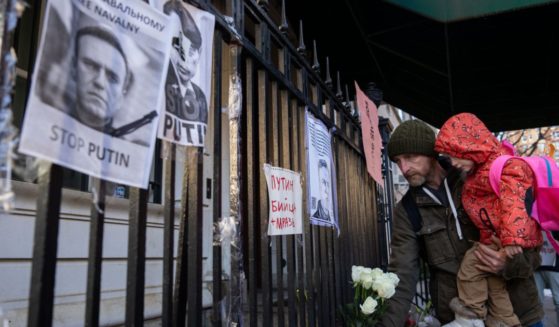 People leave flowers as they attend a memorial for Vladimir Putin critic Alexei Navalny at the Russian Consulate in New York City on Friday.