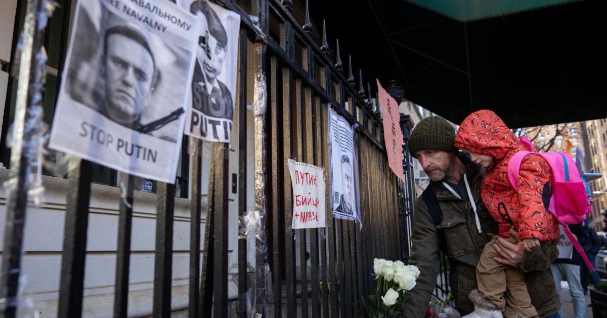 People leave flowers as they attend a memorial for Vladimir Putin critic Alexei Navalny at the Russian Consulate in New York City on Friday.