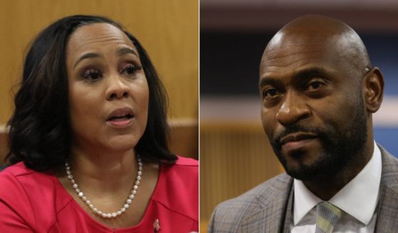 Judge Scott McAfee ruled on Monday that the divorce attorney for Nathan Wade, right, would have to retake the stand in the proceedings to determine if Wade and District Attorney Fani Willis, left, should be disqualified from the case involving former President Donald Trump.