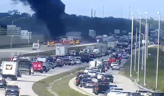 Smoke fills the air after an airplane crashed on Interstate 75 on Friday near Naples, Florida. Two people died in the crash.