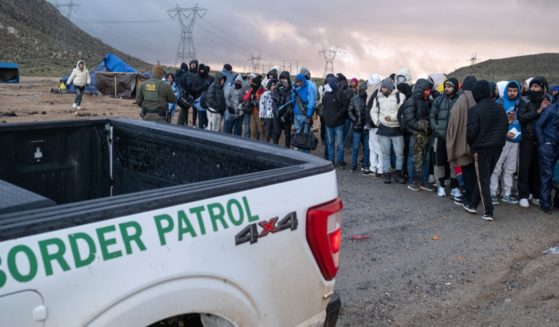 Illegal immigrants wait in line to be processed Jan. 2 by the Border Patrol at a makeshift camp near the U.S.-Mexico border in San Diego County, California.