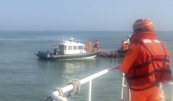 aiwanese coast guards inspect a vessel that capsized during a chase off the coast of Kinmen archipelago in Taiwan on Wednesday.