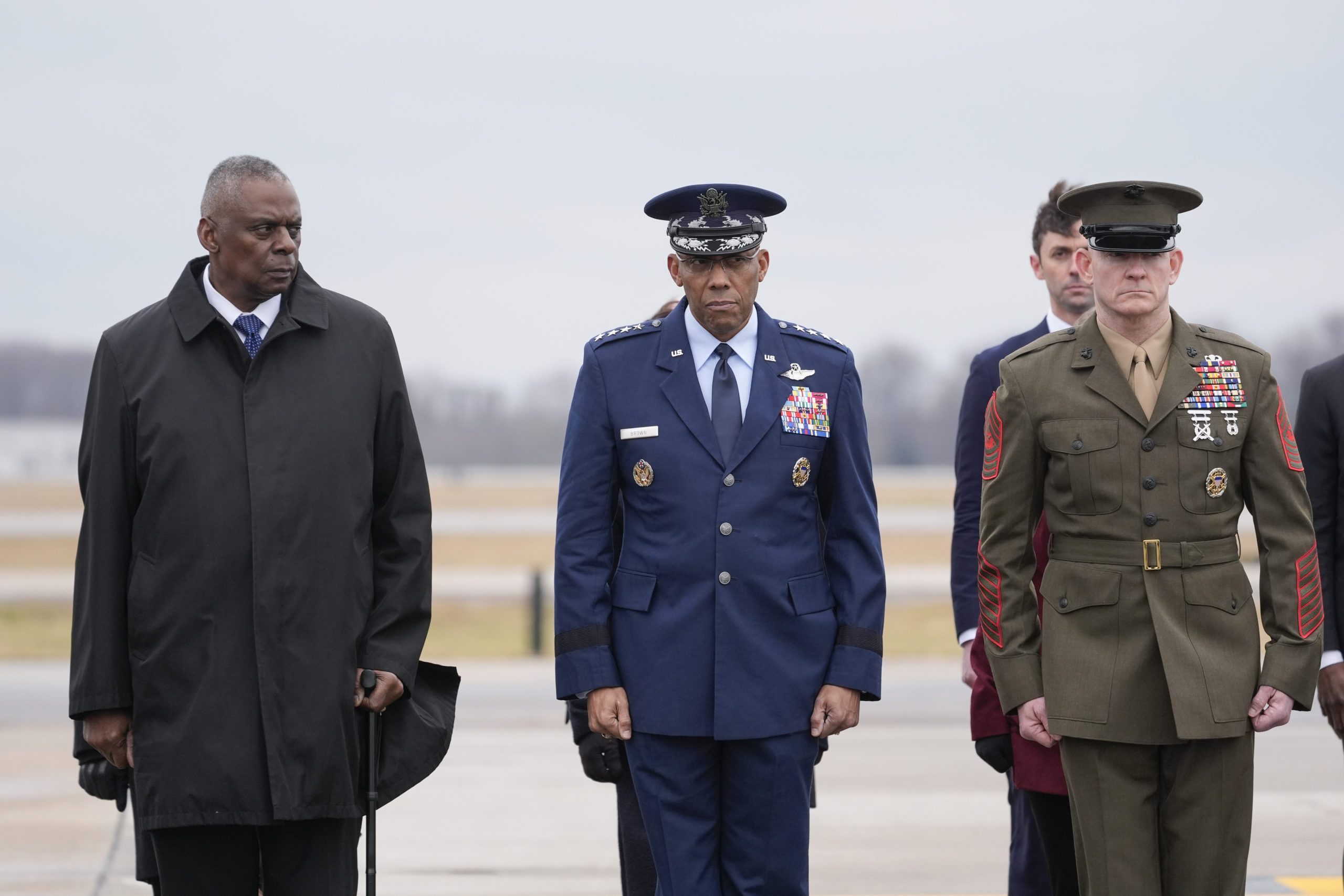 Defense Secretary Lloyd Austin, Chairman of the Joint Chiefs of Staff Gen. Charles Q. Brown, and Marine Corps. Sgt. Maj. Troy E. Black watch as an Army carry team moves the flag-draped transfer case containing the remains of U.S. Army Sgt. Kennedy Ladon Sanders, 24, of Waycross, Georgia, during a casualty return at Dover Air Force Base in Delaware on Friday. Sanders was killed in a drone attack in Jordan on Sunday.