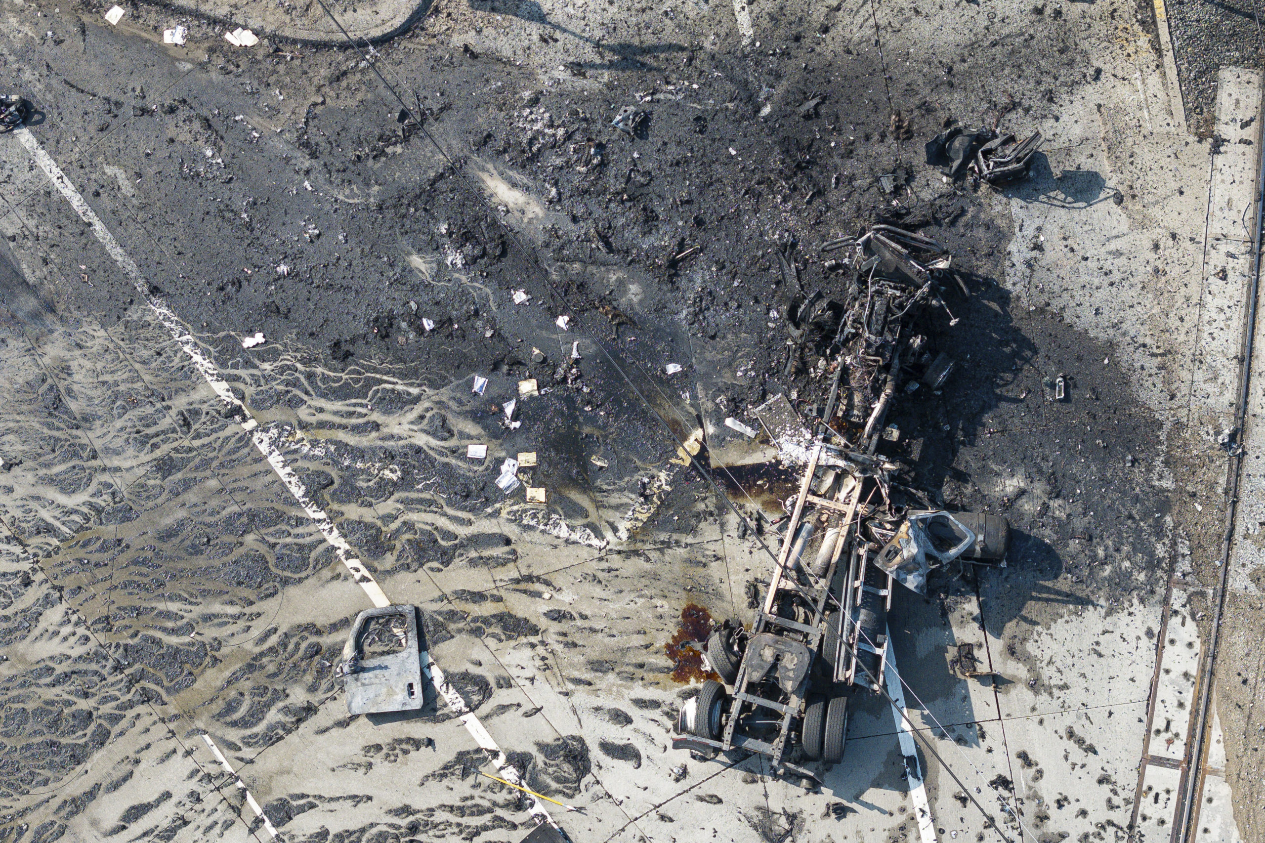 The tractor portion of a big rig is shown in an aerial view Thursday in the Wilmington section of Los Angeles. Several Los Angeles firefighters were injured, two critically, when an explosion occurred as they responded to a truck with pressurized cylinders that were on fire early that day.