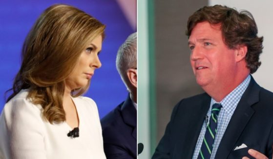 CNN host Erin Burnett, pictured left as a moderator of a Democratic primary debate in October 2019, was scathing in her report on an interview of Russian President Vladimir Putin by former Fox News host Tucker Carlson, pictured right in a November file photo.