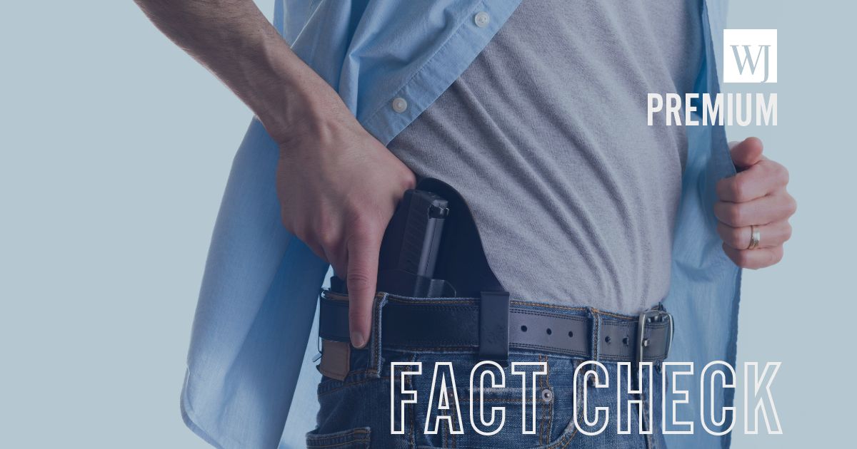 A man draws a gun from a holster in this stock image.