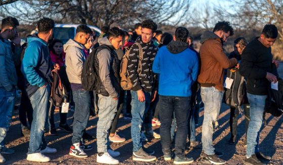 A group of migrants is processed by Border Patrol after crossing into the U.S. illegally on Feb. 4 outside Eagle Pass, Texas.