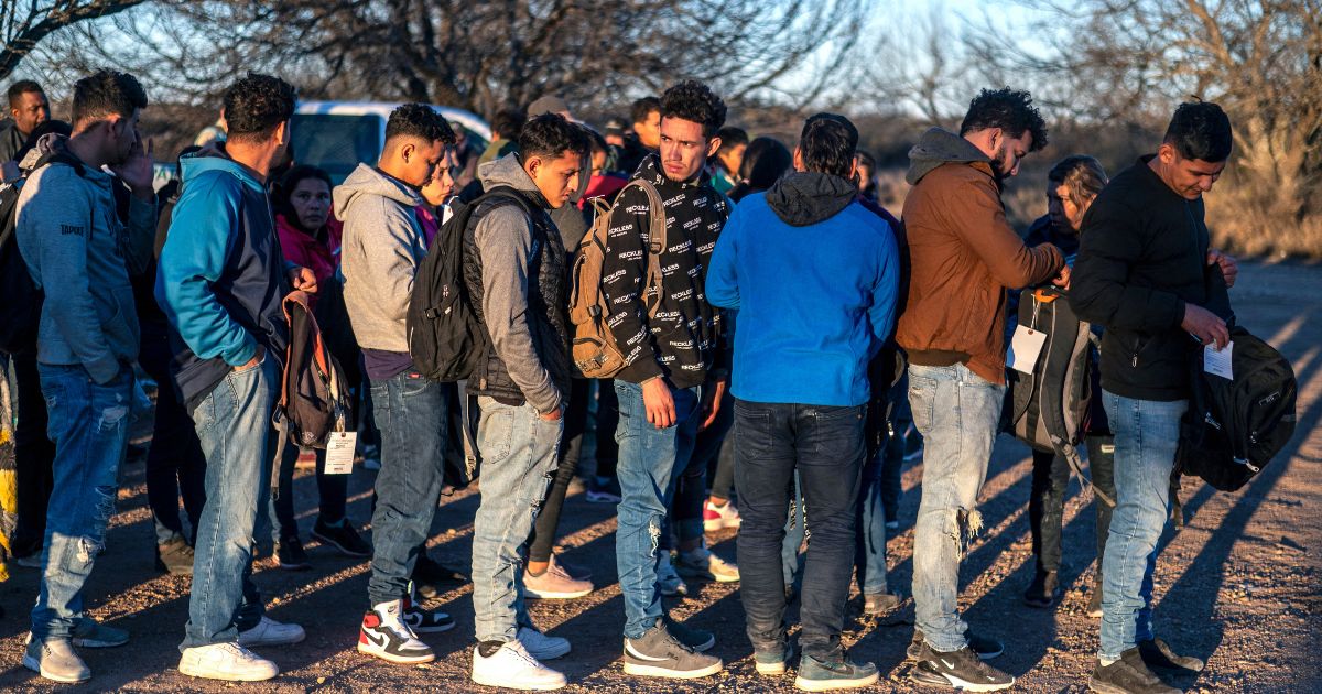 A group of migrants is processed by Border Patrol after crossing into the U.S. illegally on Feb. 4 outside Eagle Pass, Texas.