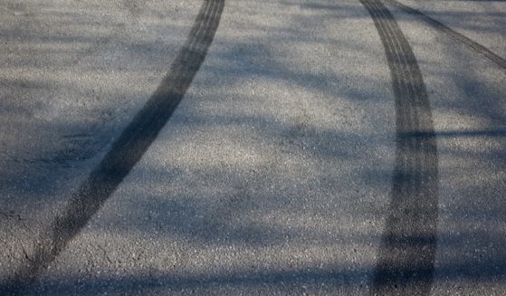 A stock image of skidmarks on a street.