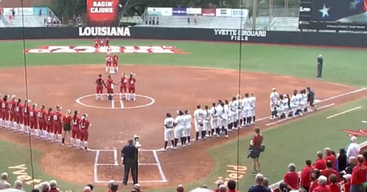 Softball players from the University of California, Berkeley, kneel during the national anthem prior to a Feb. 9 game at the University of Louisiana, Lafayette.