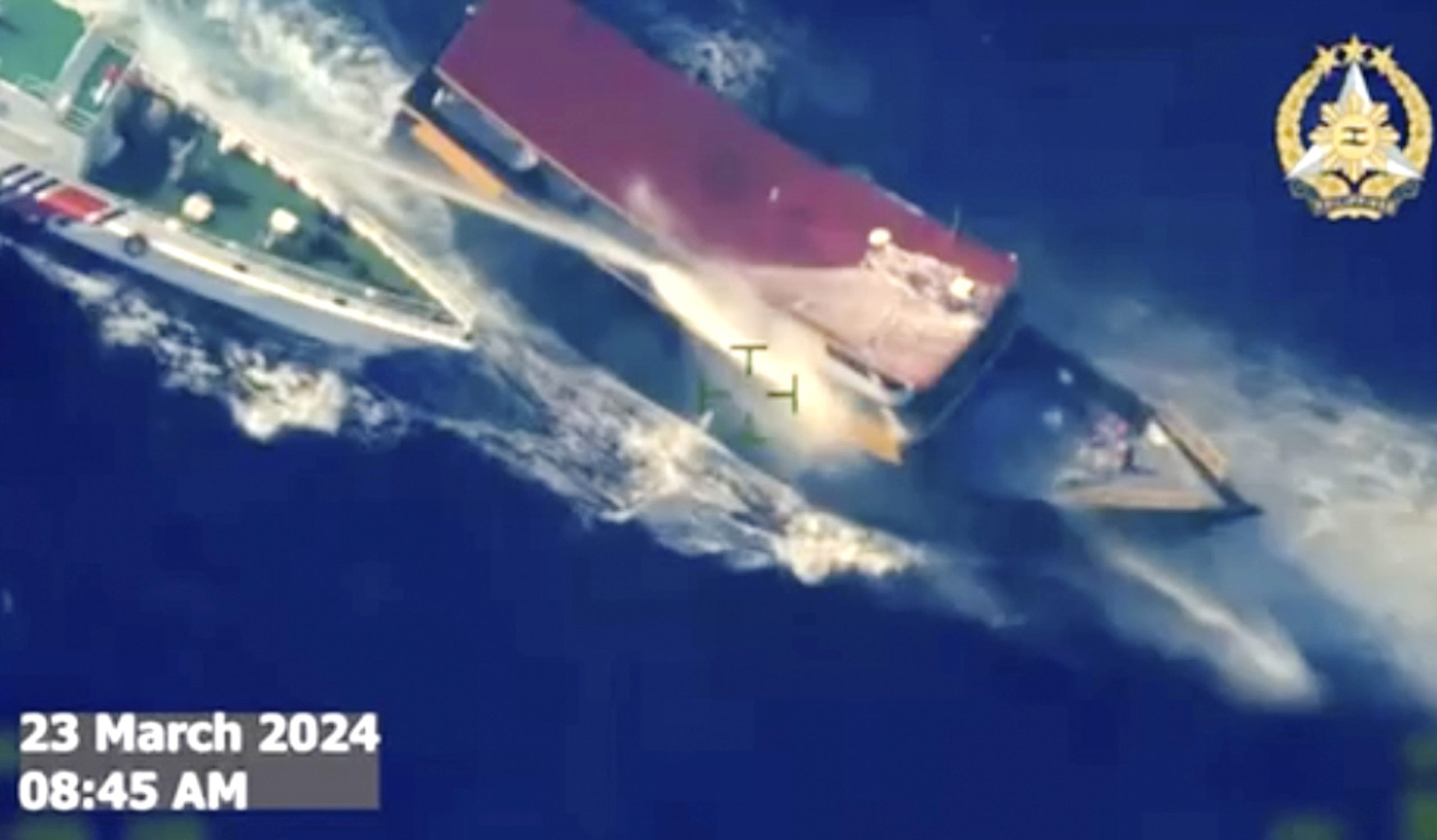 In this screen grab from video, a Chinese coast guard ship uses water cannons and closely maneuvers beside a Philippine resupply vessel as it approaches Second Thomas Shoal, at the disputed South China Sea on Saturday.