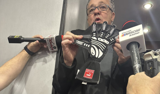 NASCAR Cup Series Managing Director Brad Moran shows reporters the illegal glove Joey Logano of Team Penske was reportedly caught wearing during qualifying in February at Atlanta Motor Speedway.
