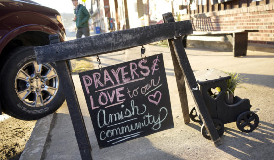 A sign of comforting words sits on the sidewalk outside an antique store in Spartansburg, Pennsylvania, on Thursday in the wake of the slaying of a pregnant Amish woman, 23, last week.