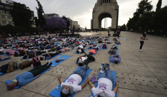 People lie at the base of the Monument to the Revolution to take a nap Friday in Mexico City in commemoration of World Sleep Day.