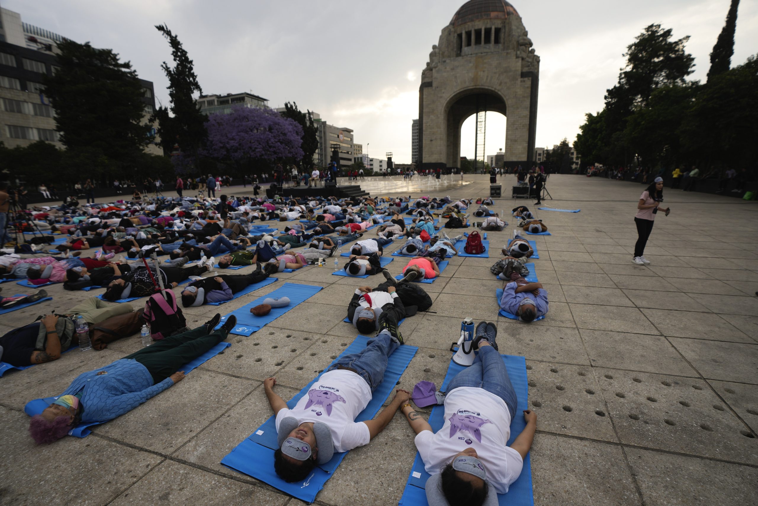 People lie at the base of the Monument to the Revolution to take a nap Friday in Mexico City in commemoration of World Sleep Day.