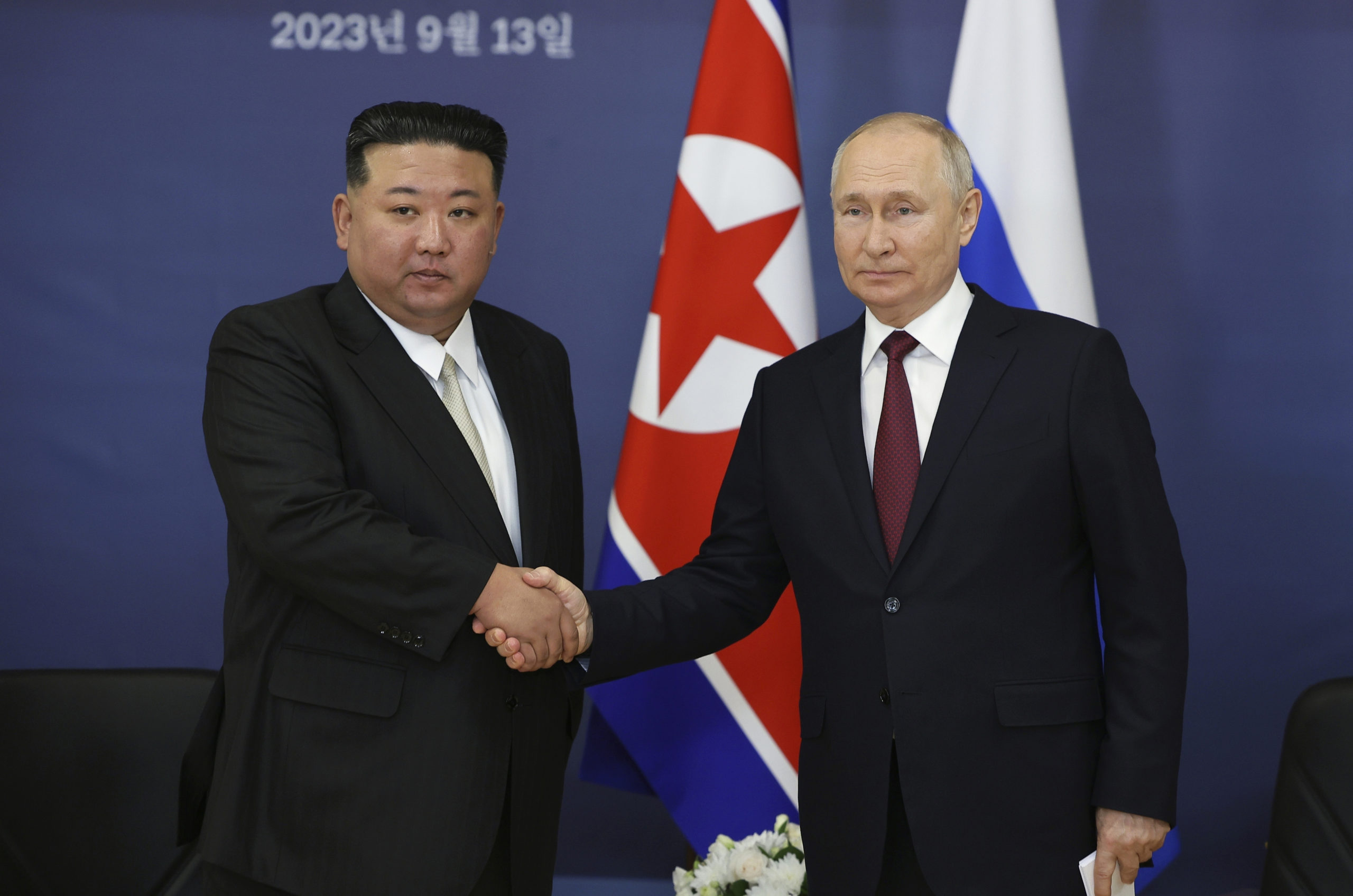 Russian President Vladimir Putin, right, and North Korea's leader Kim Jong Un are seen shaking hands in a file photo taken during a September meeting.