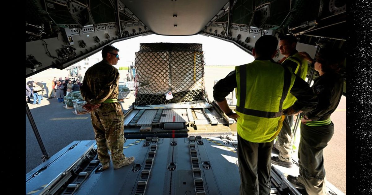 Belgian Air Force soldiers load a military cargo plane with humanitarian aid to be dropped over the Gaza strip, at the military aerodrome in Melsbroek, northeast of Brussels, on March 4.