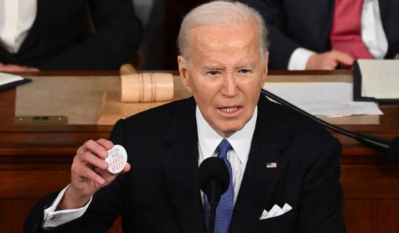 President Joe Biden holds a Laken Riley button while delivering the State of the Union address in the House Chamber of the U.S. Capitol in Washington, D.C. Thursday.