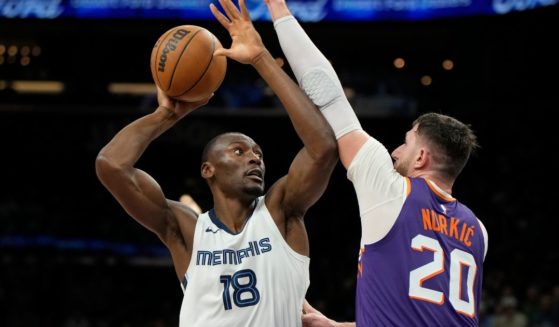 Bismack Biyombo, left, then with the Memphis Grizzlies, shoots over Phoenix Suns center Jusuf Nurkic during a Jan. 7 game in Phoenix. He joined the Oklahoma City Thunder on Feb. 10.
