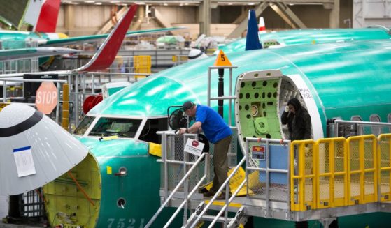 Employees work on Boeing 737 MAX airplanes at the Boeing Factory in Renton, Washington, in this file photo from March 2019.