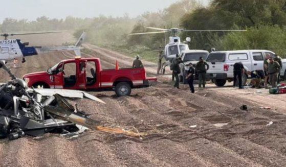 Officials respond to the site of Friday's National Guard helicopter crash near La Grulla, Texas.