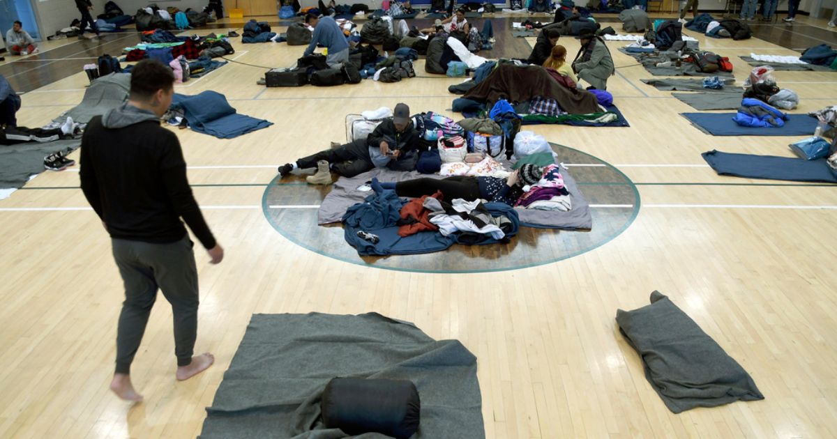 Migrants rest at a makeshift shelter in Denver, Jan. 6, 2023.