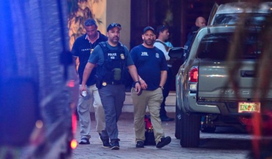 Homeland Security Investigation agents are seen at the entrance of Sean "Diddy" Combs's home at Star Island in Miami Beach on Monday.